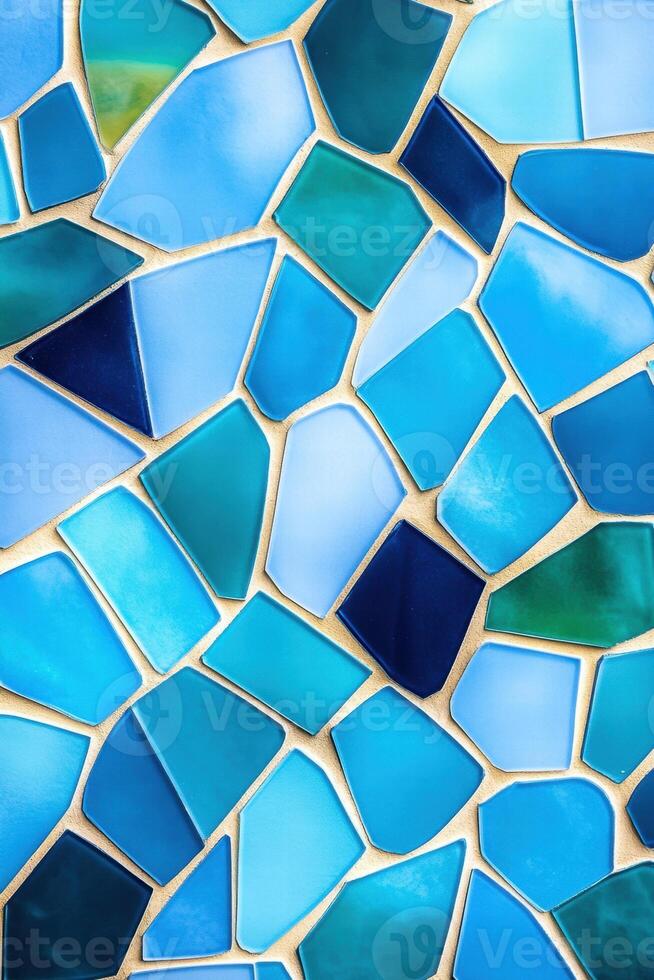 Modern mosaic design featuring turquoise, aquamarine, and soft blue tiles arranged in a dynamic geometric pattern photo