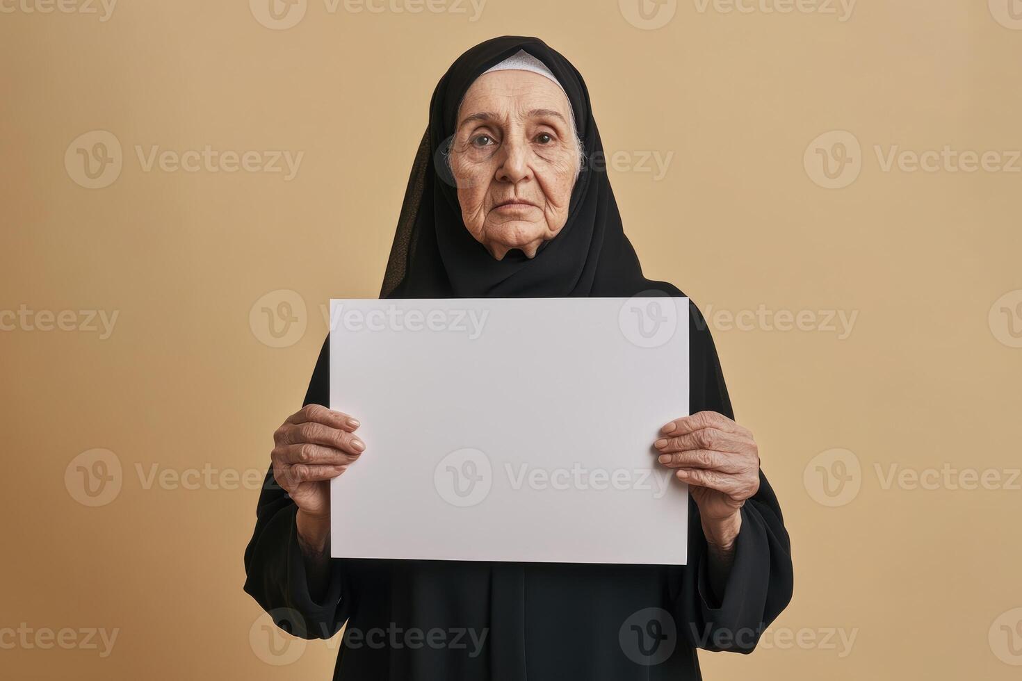 Elderly Woman In Hijab Holds Blank White Sign photo
