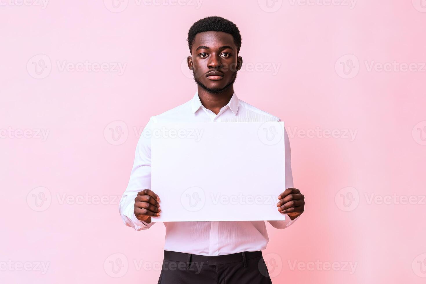 Man in white shirt holding blank sign photo