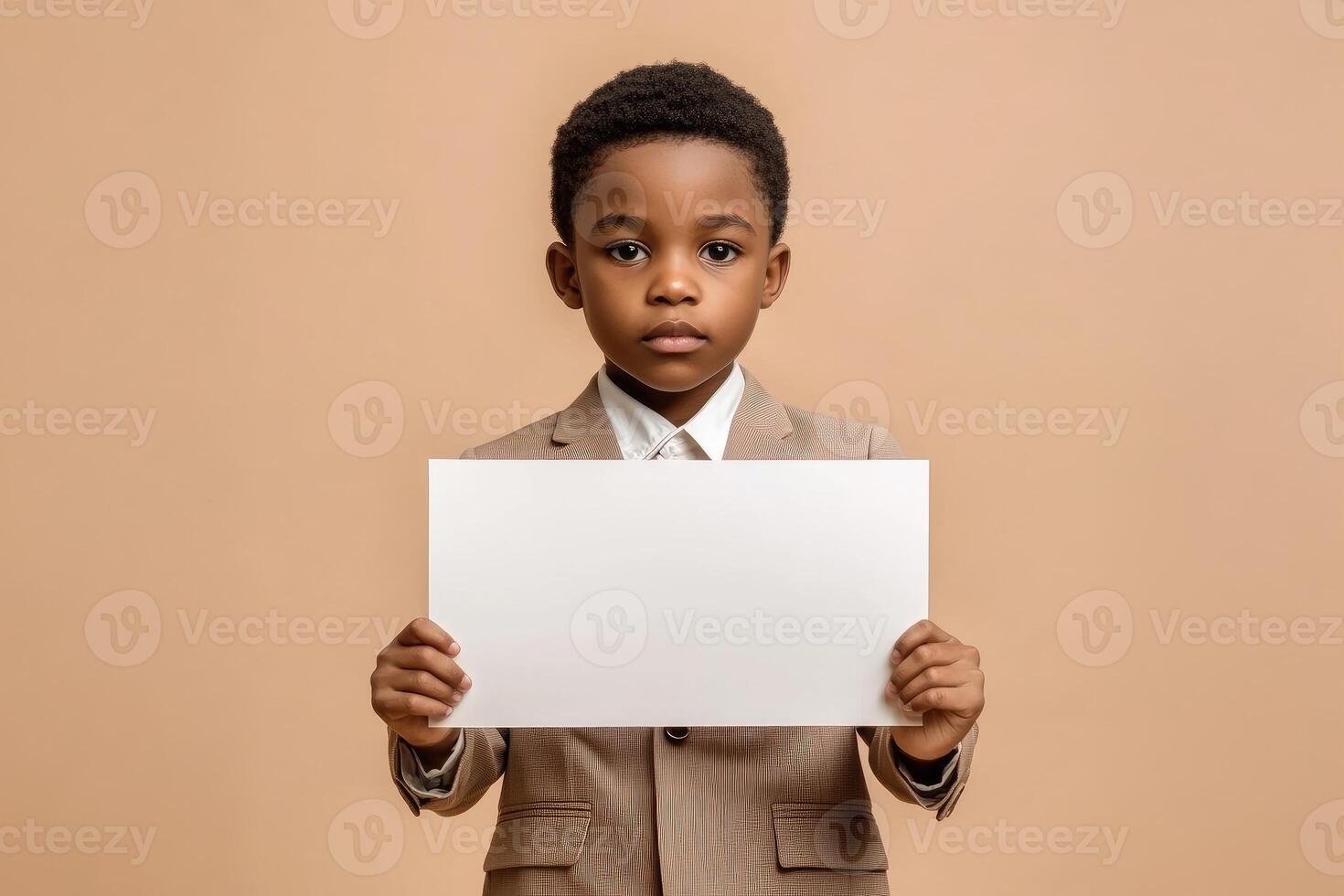 Young Boy in Suit Holds Blank White Sign photo