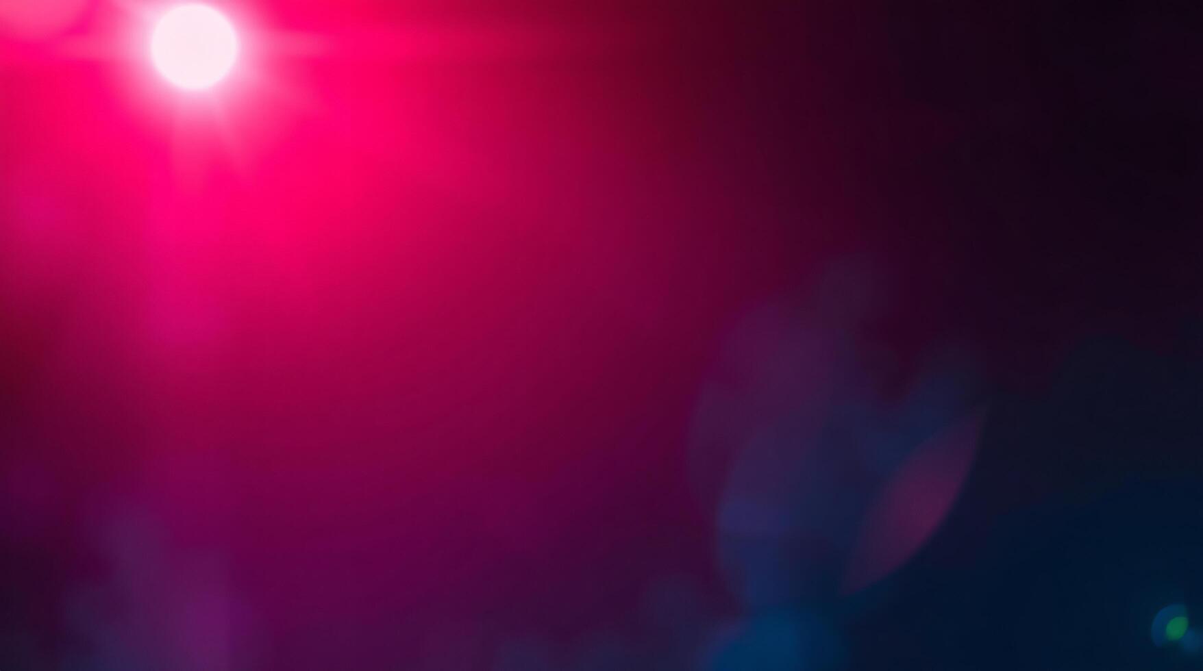 A red light is shining on a dark background photo