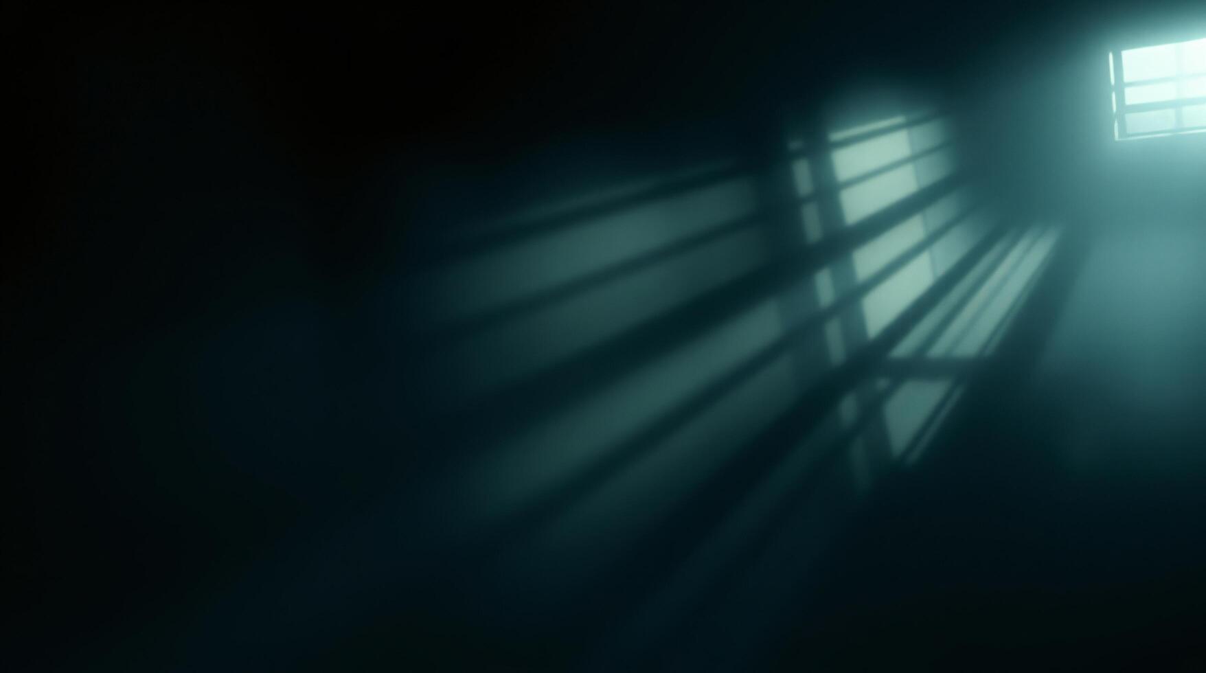 A dark room with a light shining through the window photo