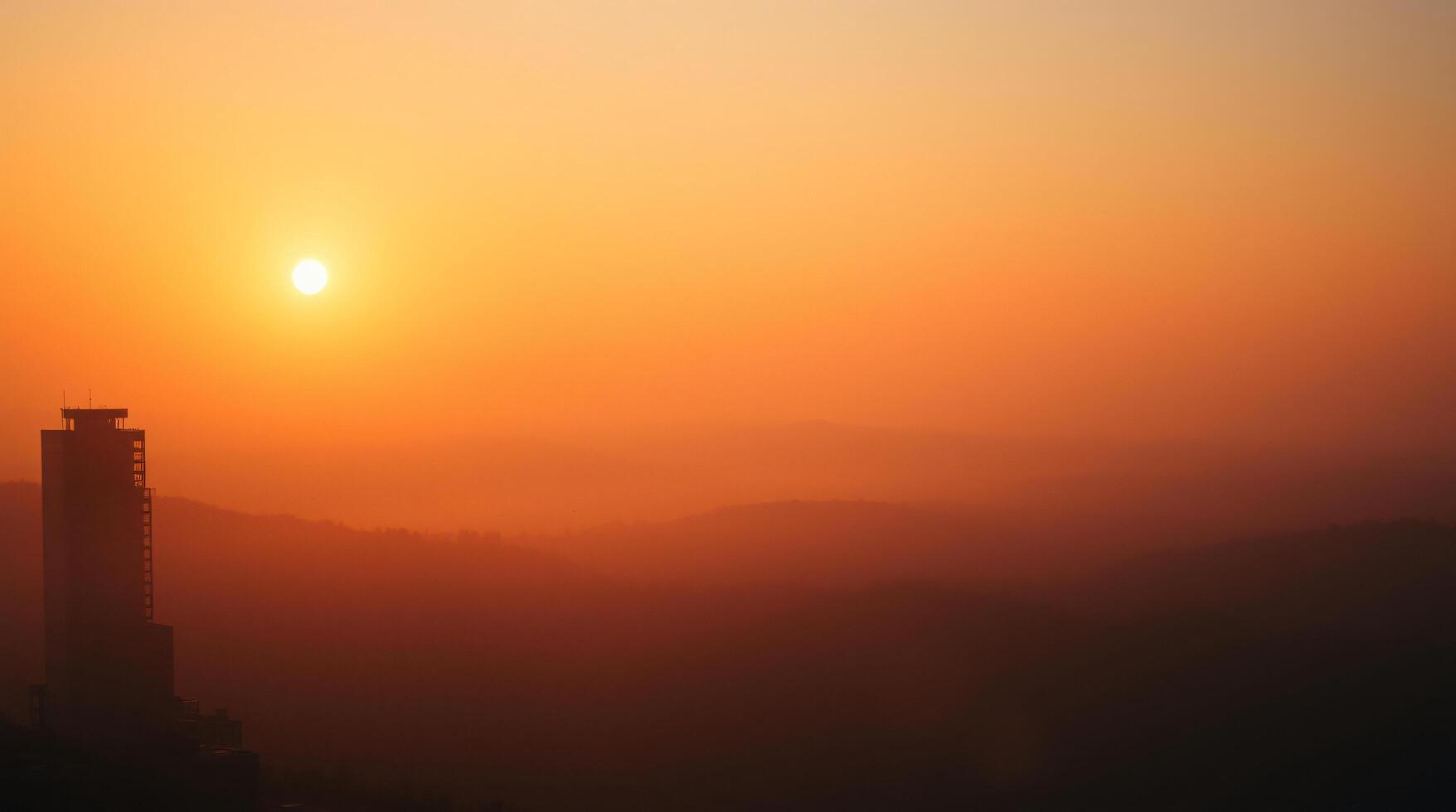 A tower is seen in the distance at sunset photo