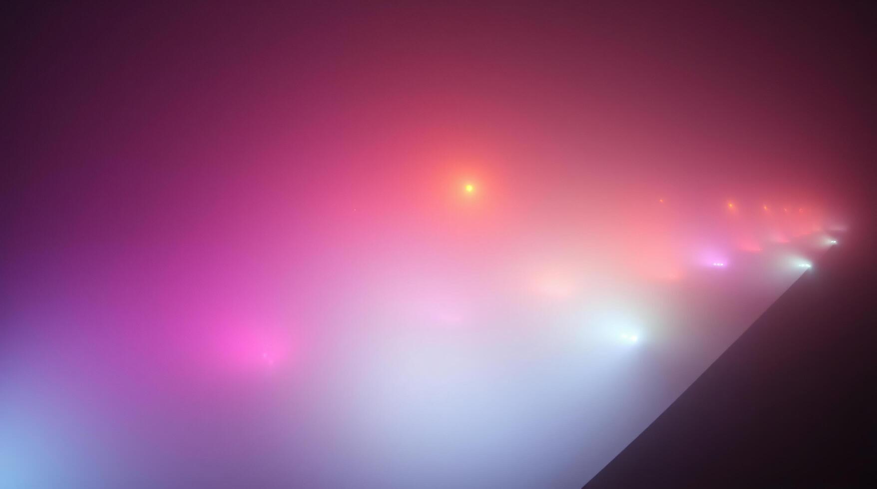 A colorful light show is shown in the dark photo