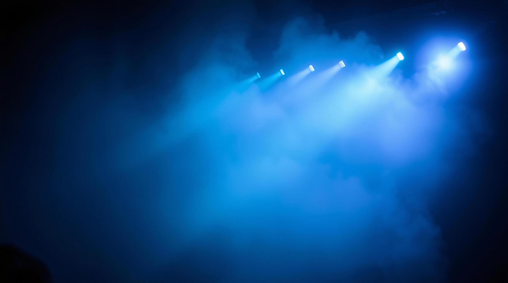 Blue light from stage lights in the dark photo