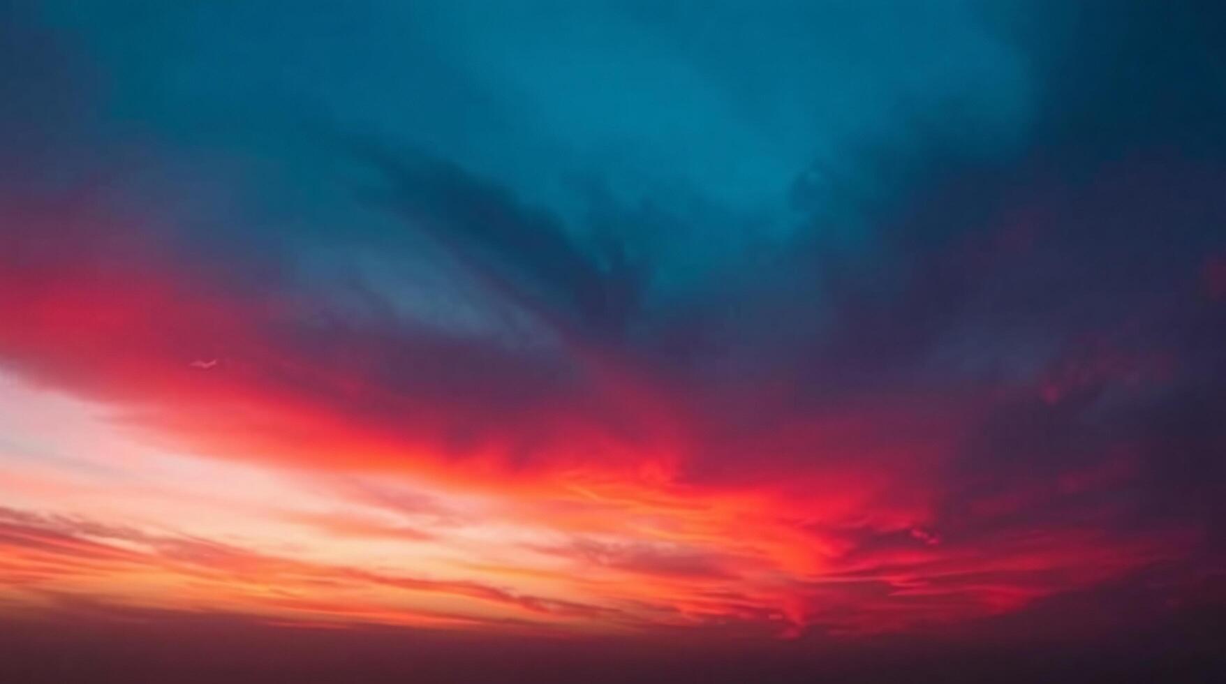 A colorful sunset over the ocean with clouds photo
