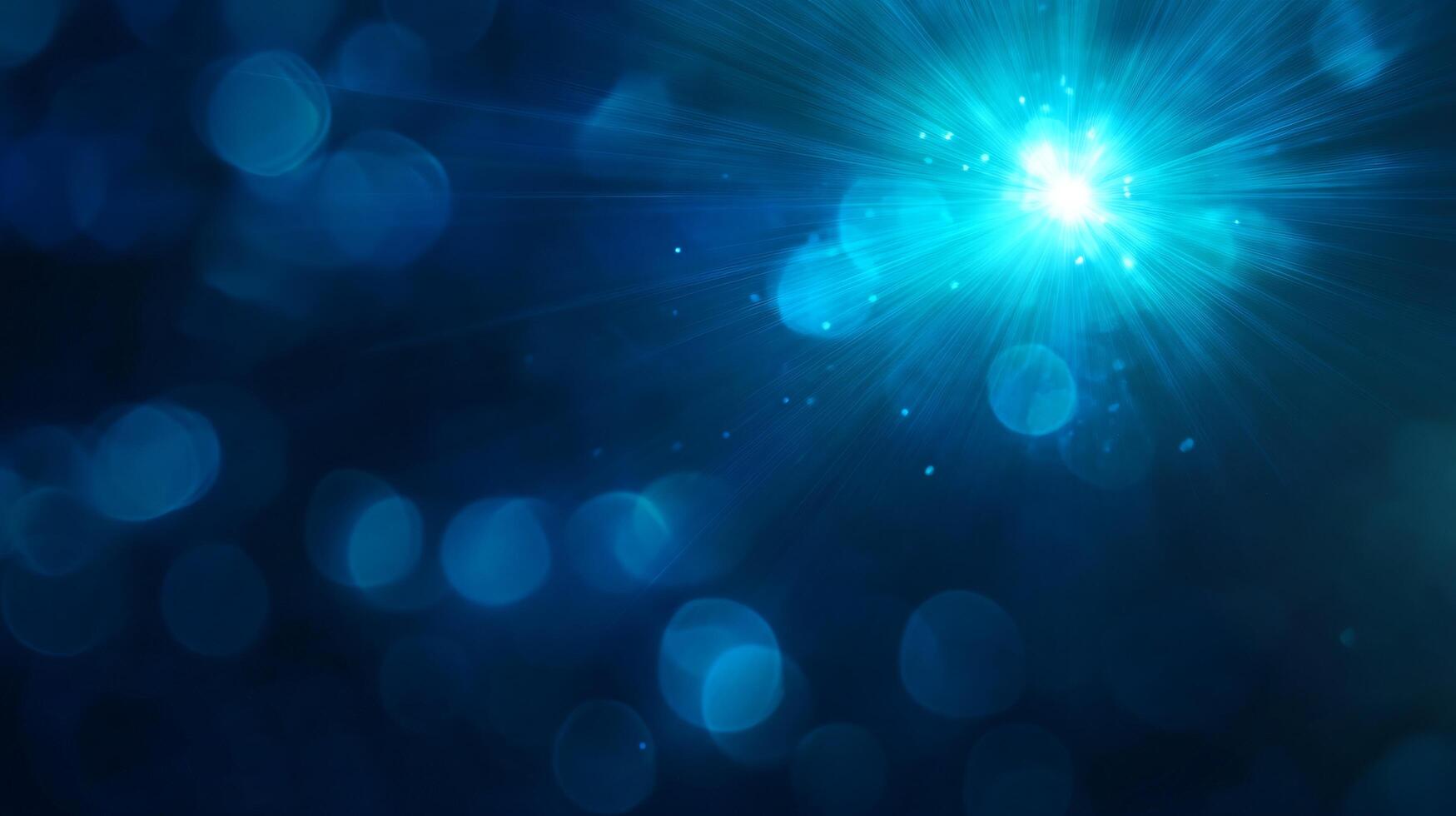 Glittering blue starburst in a bokeh effect background photo