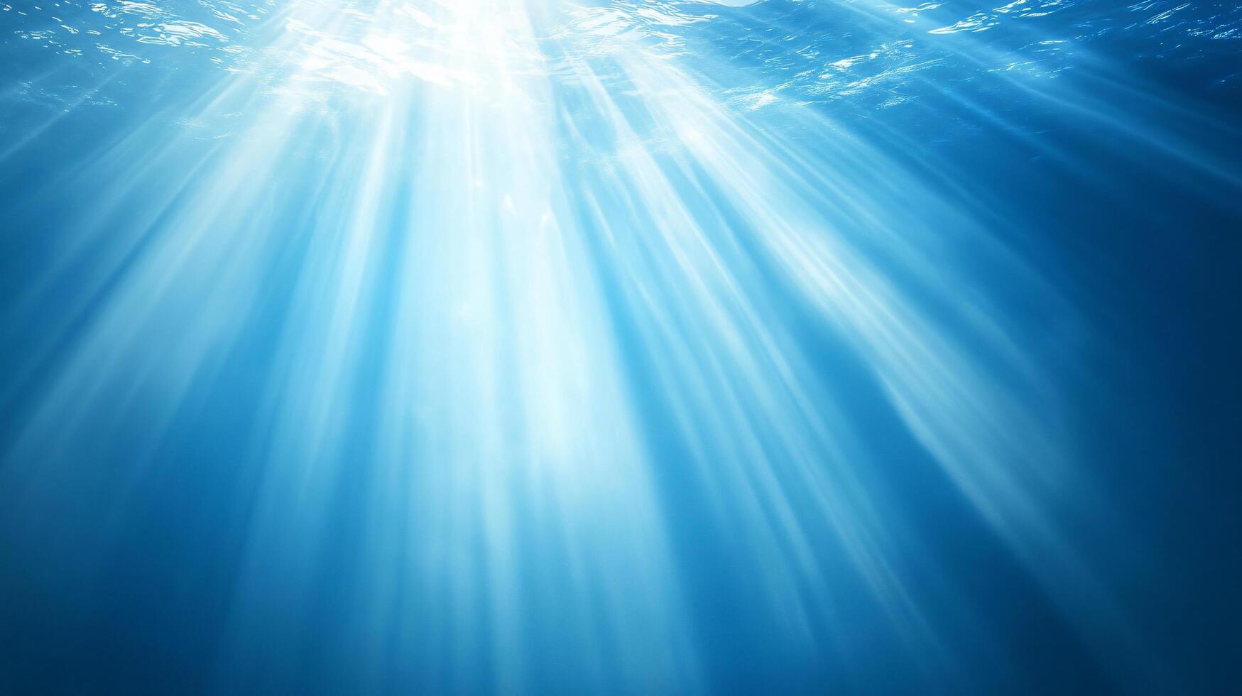 Sunrays penetrate the sea surface shining downward photo