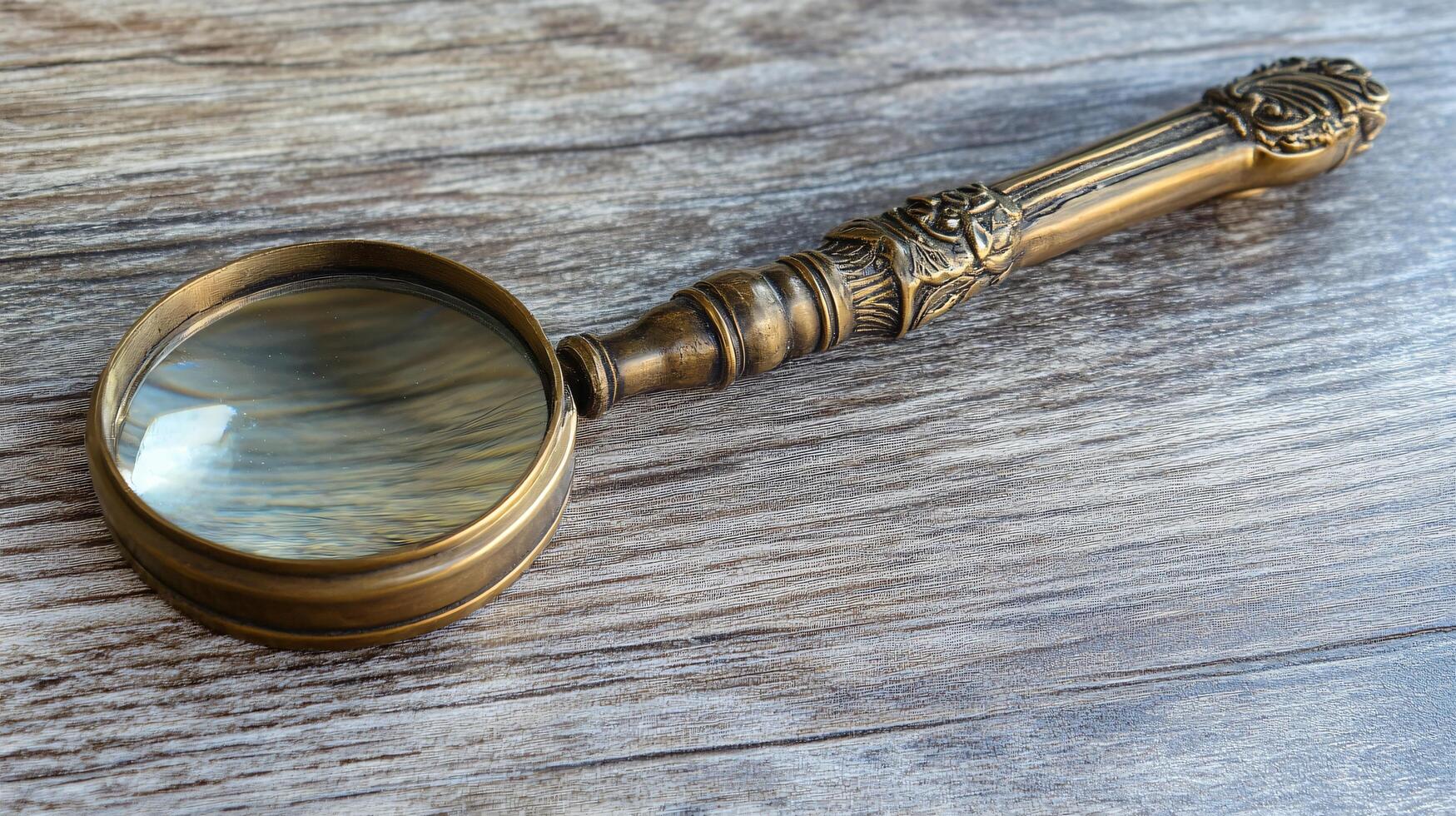 Artistic brass magnifying glass on rustic wooden table photo
