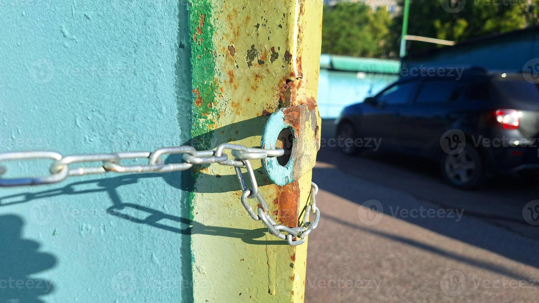 Rusty chain securing a gate on a bright sunny day photo