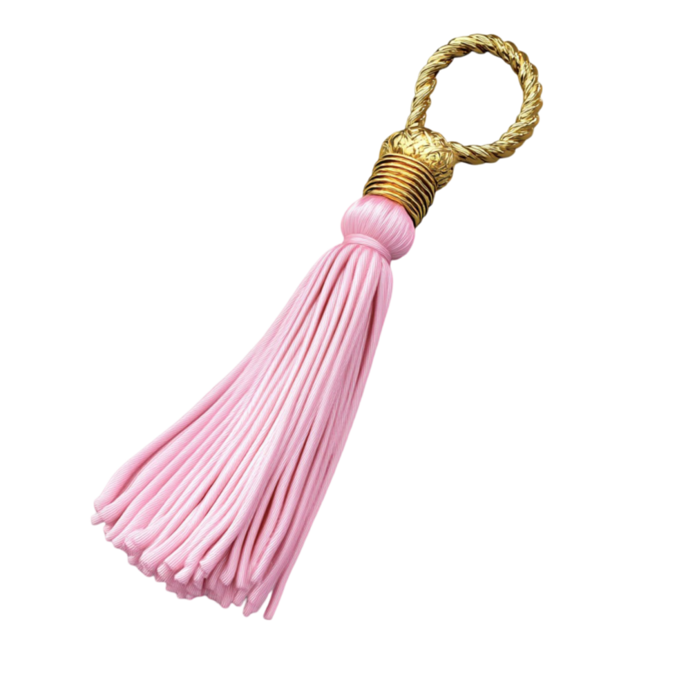 A pink tassel hanging from a gold ring png