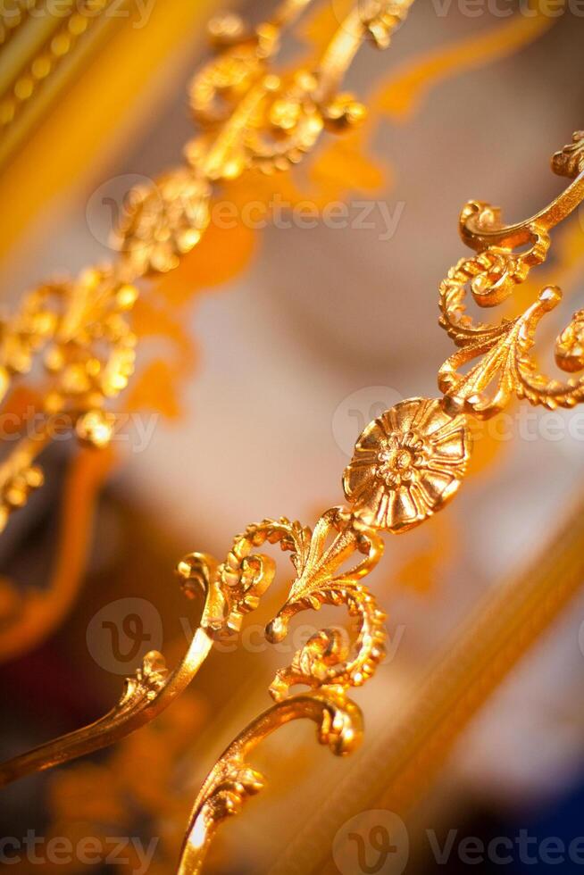 Exquisite gold ornate detailing on luxurious antique furniture photo