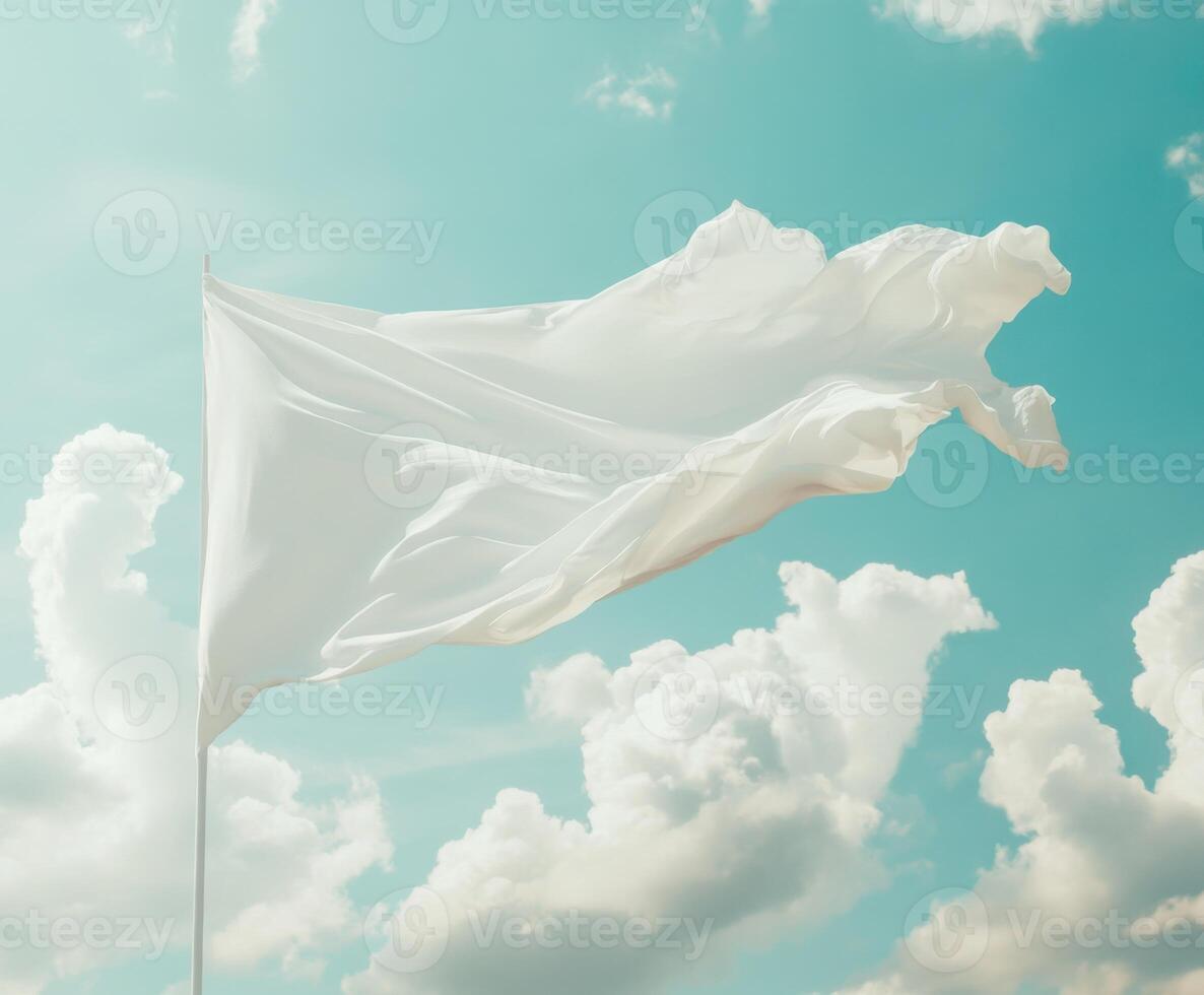 A white flag gently waves against a bright blue sky filled with fluffy clouds in the afternoon sun photo