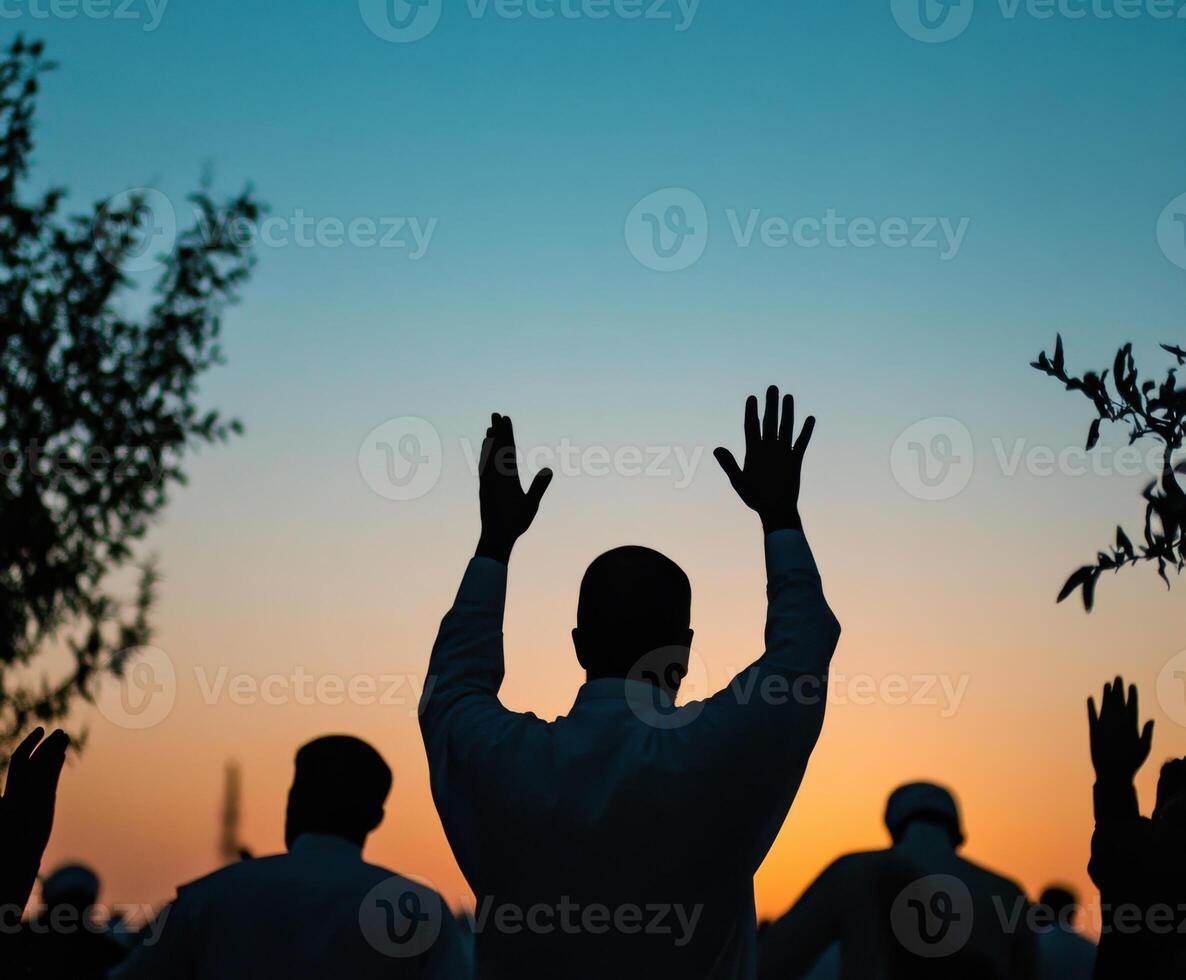 Celebration of unity during sunset with raised hands in a communal gathering photo