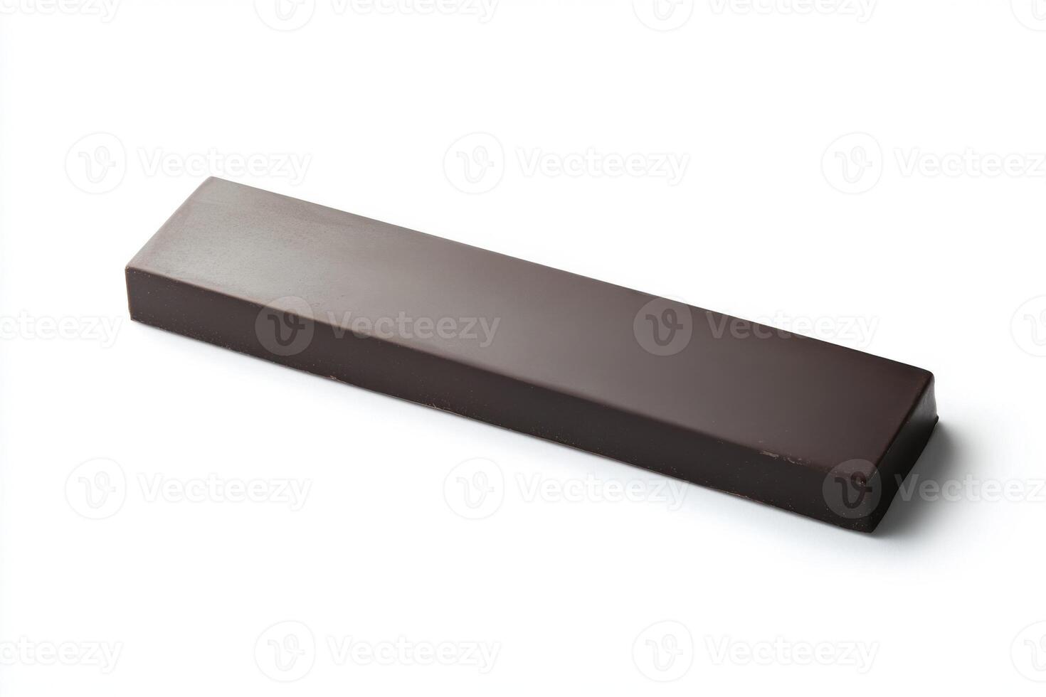 Dark chocolate bar resting on a white surface ready for tasting or culinary use photo