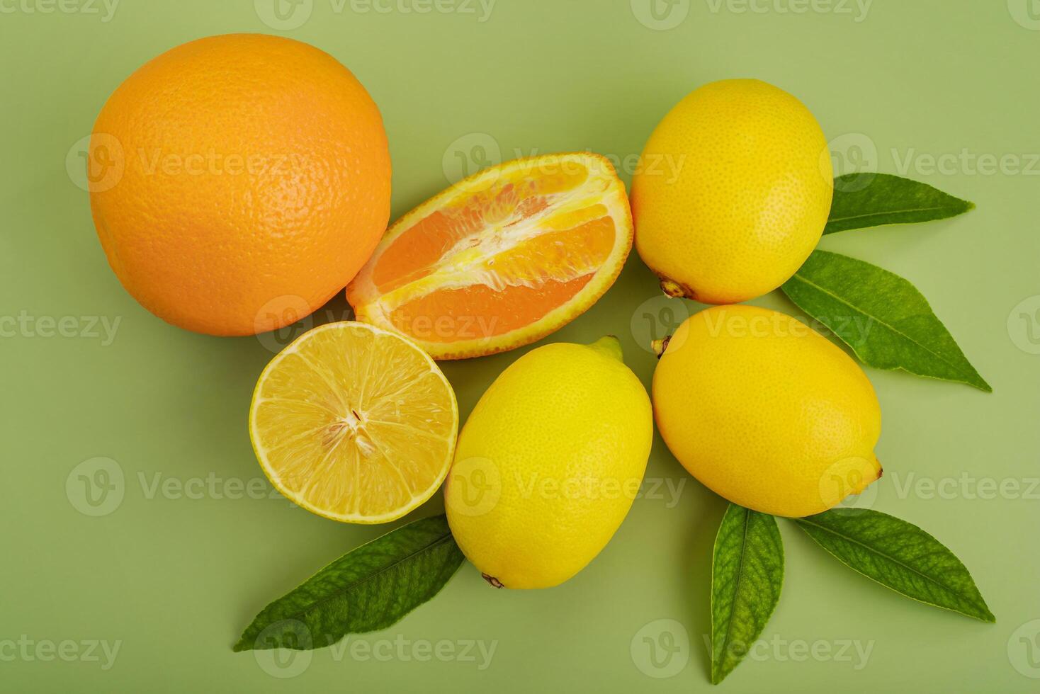 Citrus fruits. Orange oranges and yellow lemons on a green background. photo