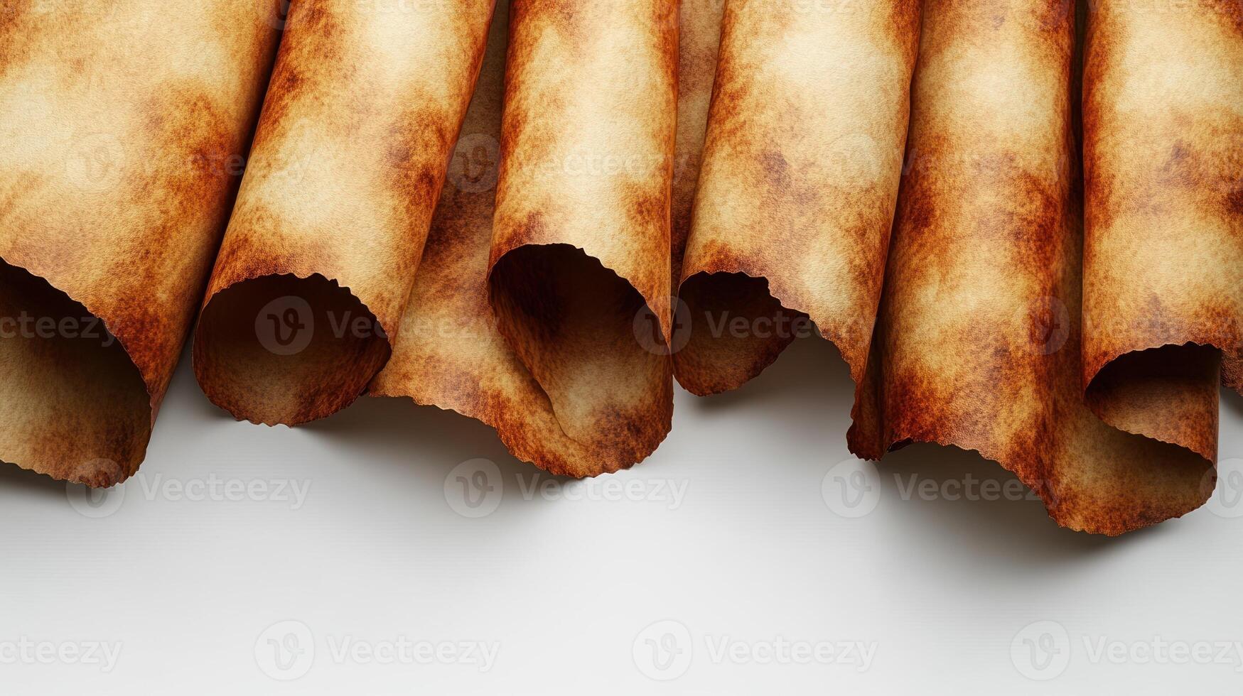 A collection of curled ancient scrolls revealing aged parchment texture photo