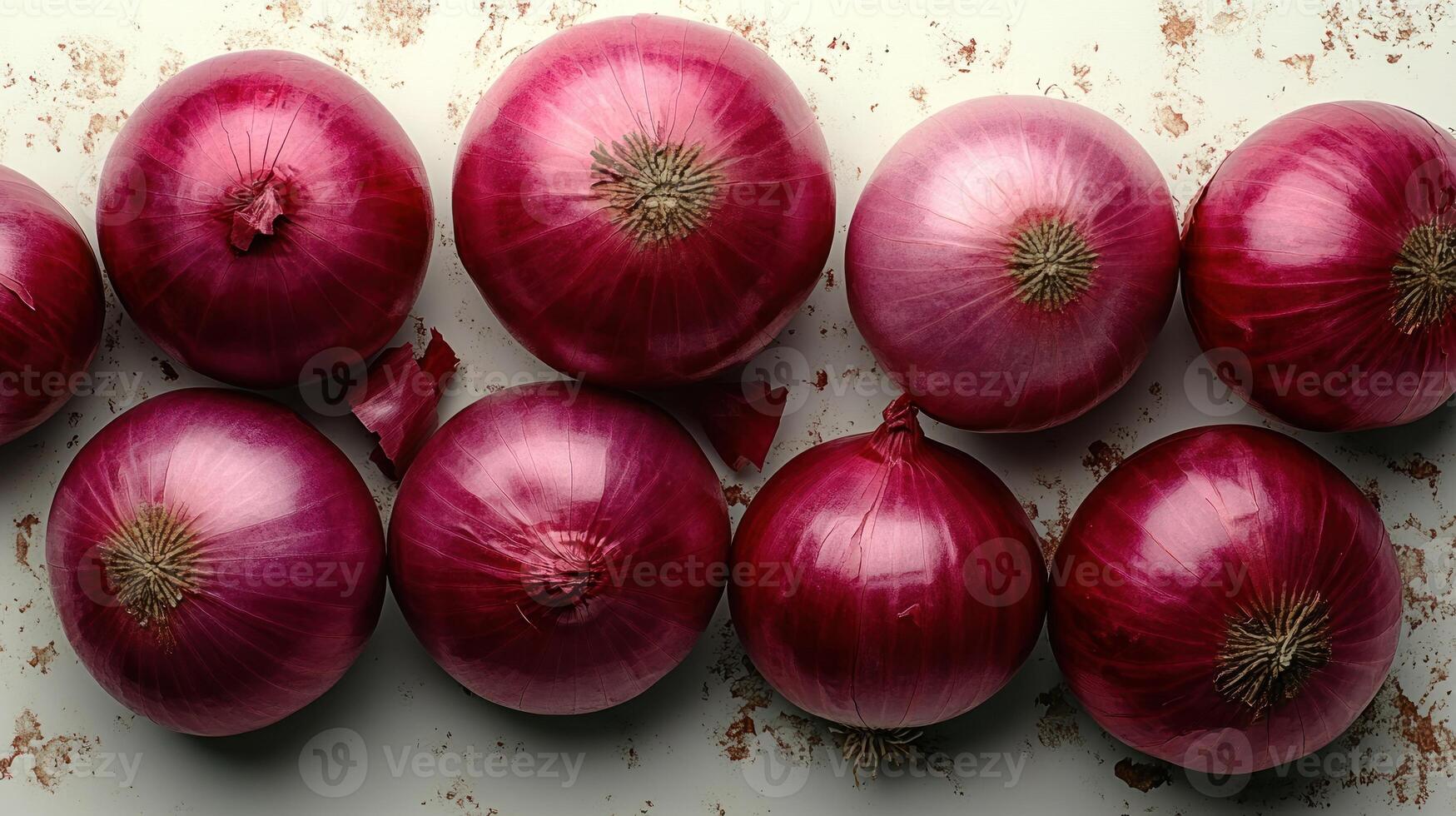 Fresh red onions arranged beautifully on a textured surface photo
