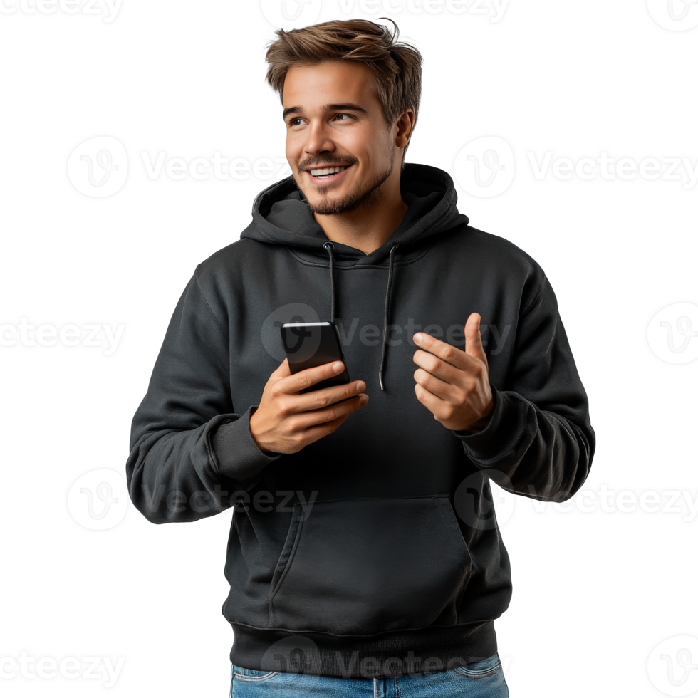 Young man in a hoodie smiles while using his smartphone indoors during daylight hours png