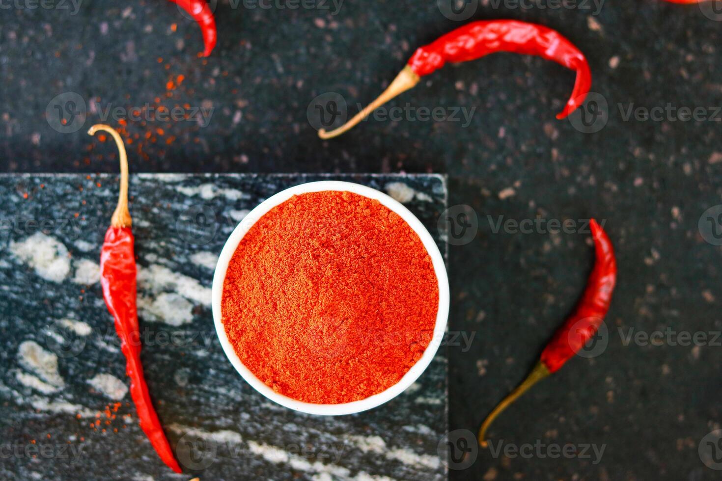 Red hot chili pepper powder in a white bowl photo