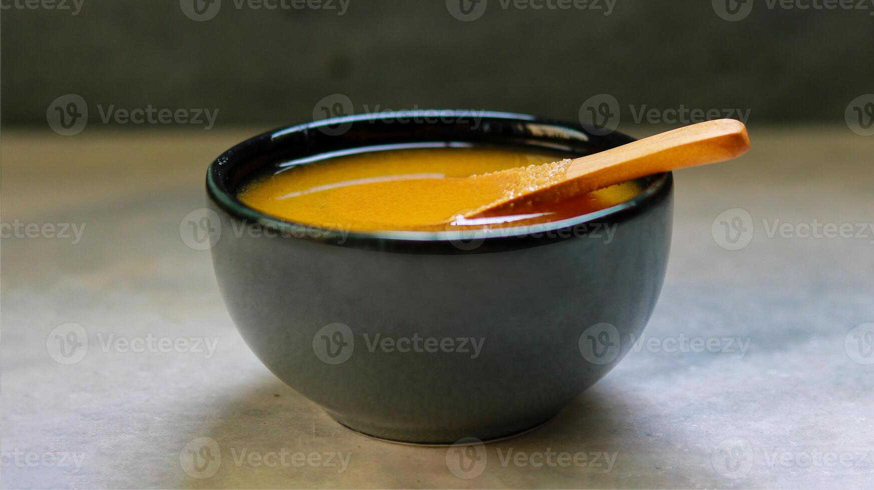 Ghee in a black ceramic bowl photo