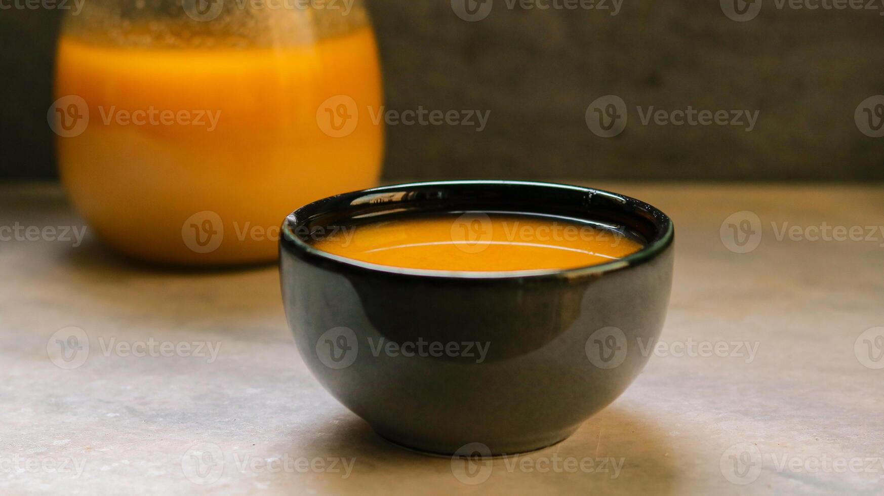 Fresh pure ghee in a black bowl on a gray background, selective focus photo