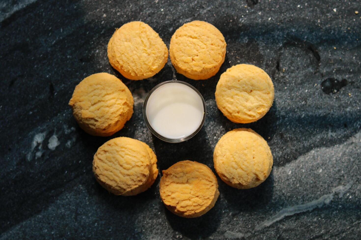 Milk in glass and cookies on the table, Top view photo
