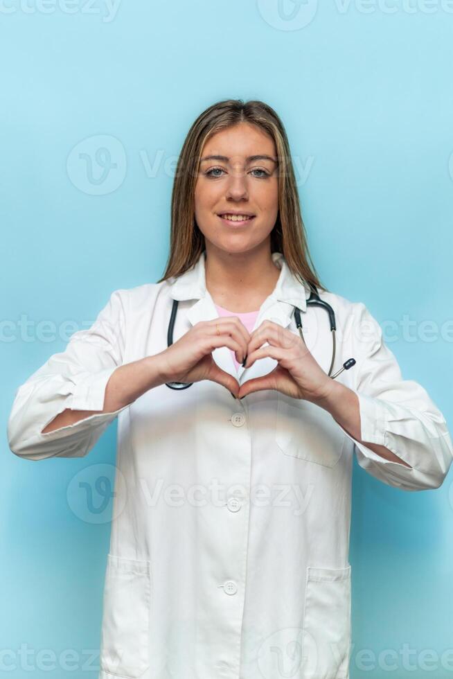 vertical Smiling doctor making heart shape with hands photo