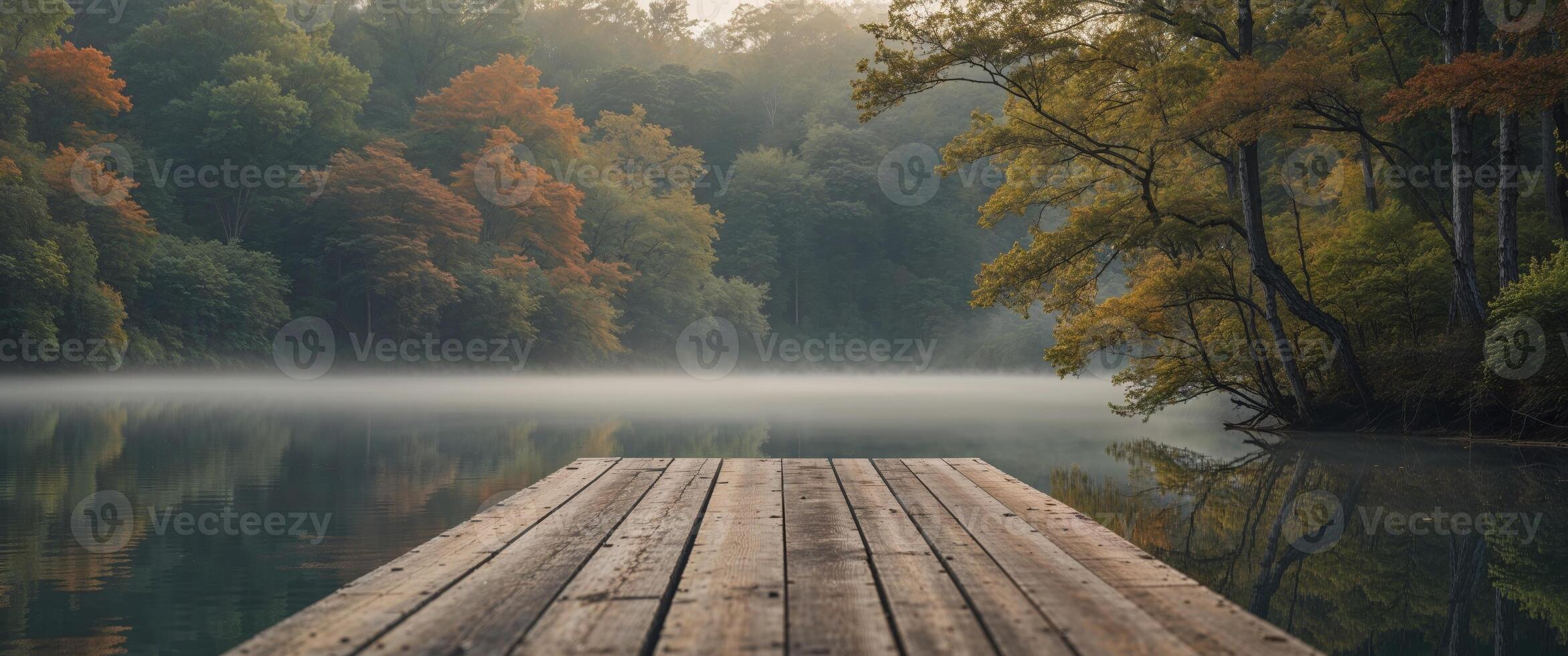 Scenic wooden dock on a tranquil lake surrounded by lush greenery and vibrant trees in a serene woodland setting. photo