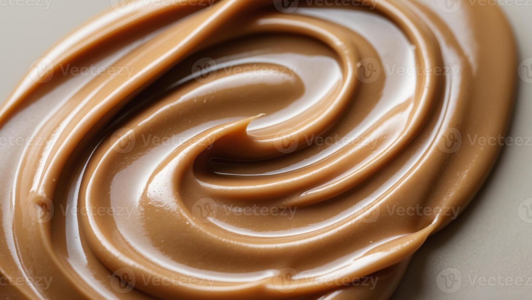 Close up of creamy smooth peanut butter texture with glossy sheen and rich golden brown color perfect for food and culinary backgrounds. photo