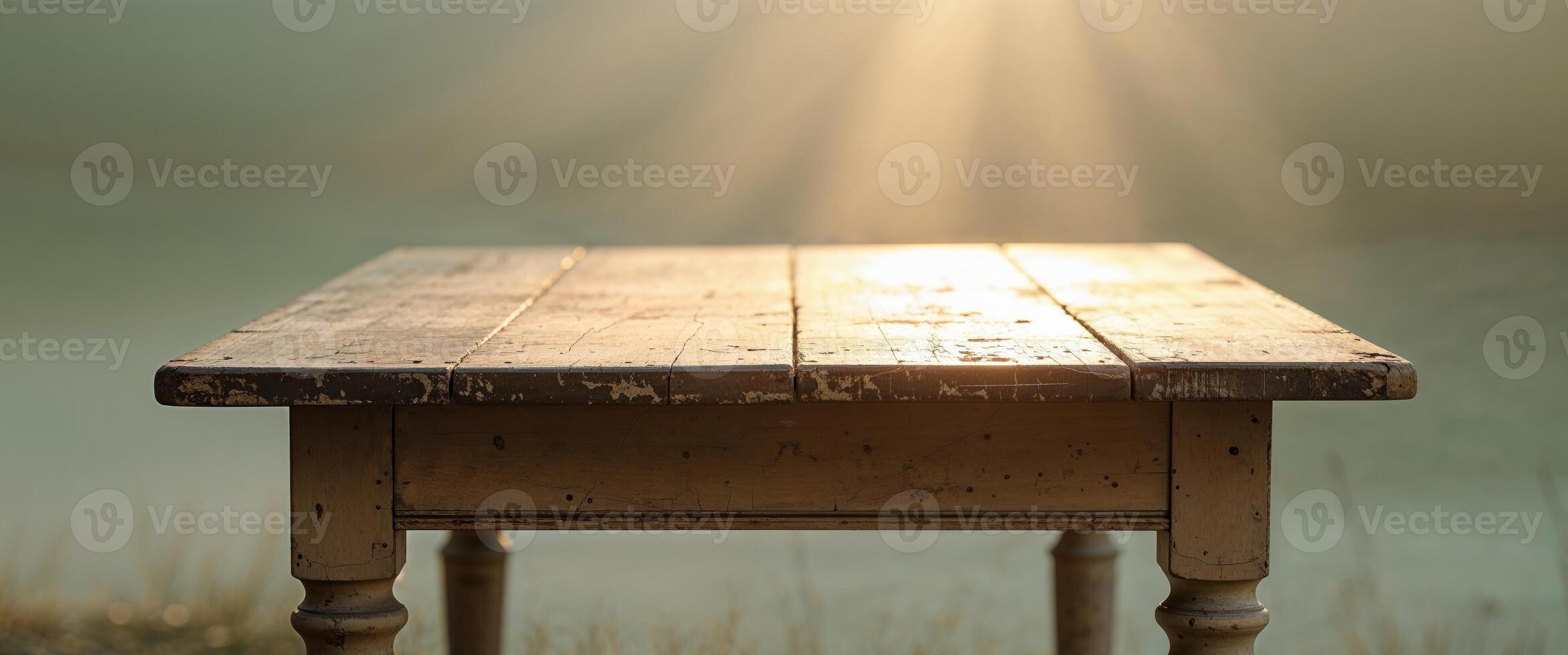 Soft sunlight casts a cozy glow on an old wooden table in a tranquil setting. photo