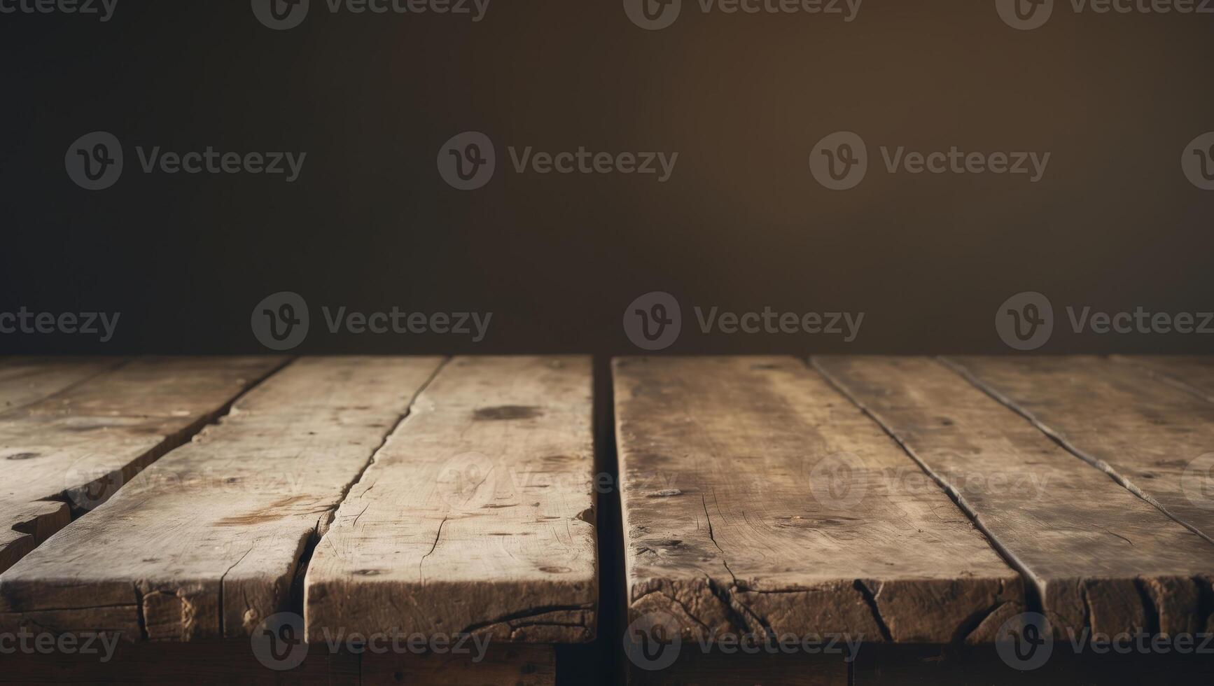 A rustic wooden table with a weathered surface illuminated by soft lighting creating a warm and vintage atmosphere in a dark setting. photo