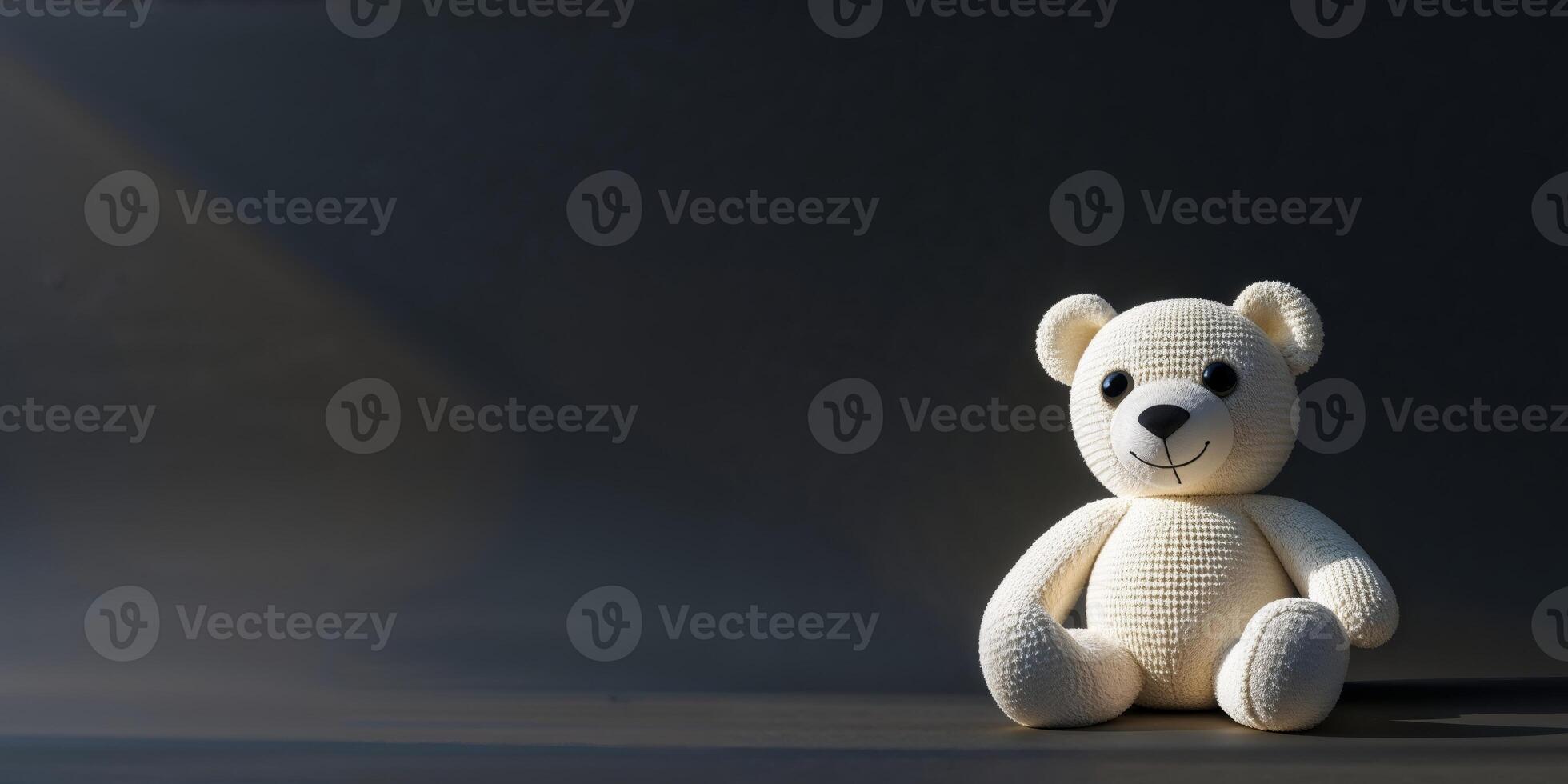 a knitted teddy bear on a black background photo