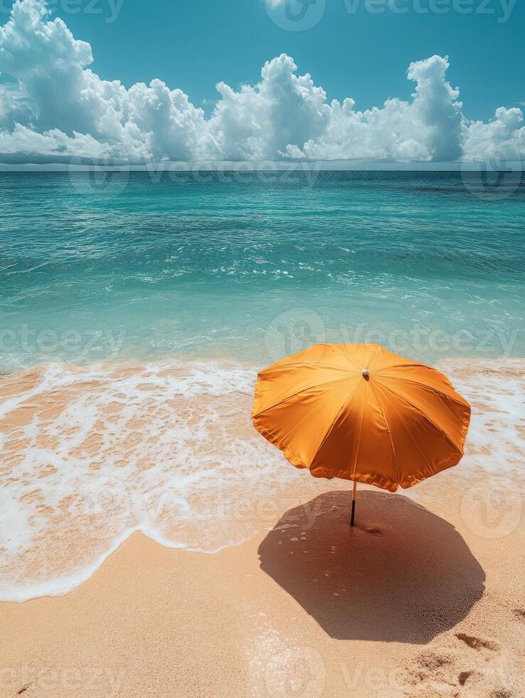 A serene beach scene featuring an orange umbrella by the turquoise ocean. photo