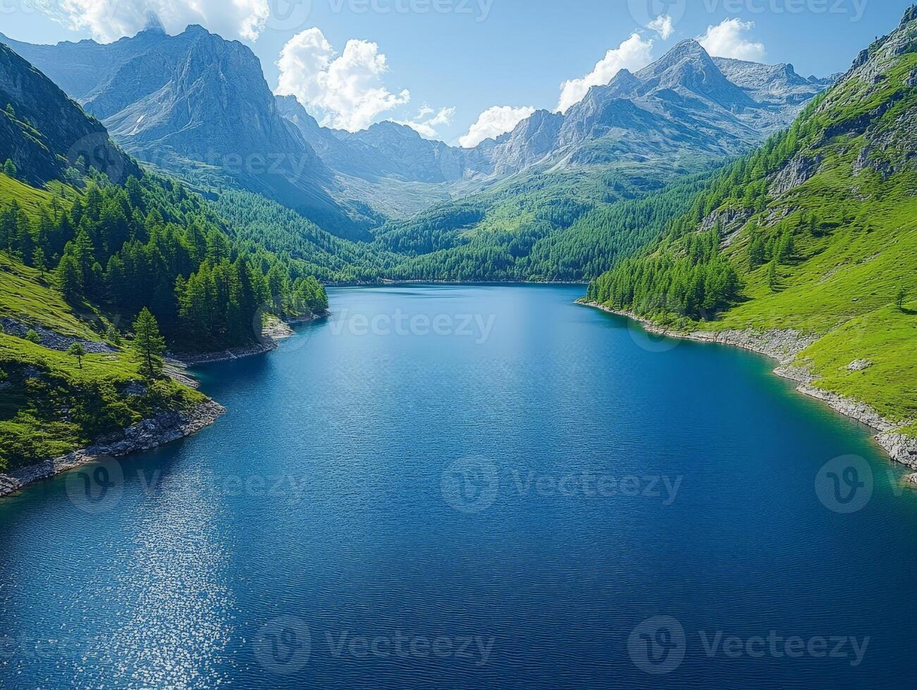 A serene mountain lake surrounded by lush greenery and towering peaks under a clear sky. photo
