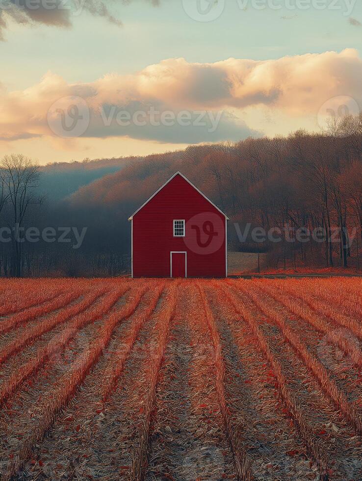A serene landscape featuring a red barn amidst autumn fields and distant hills. photo