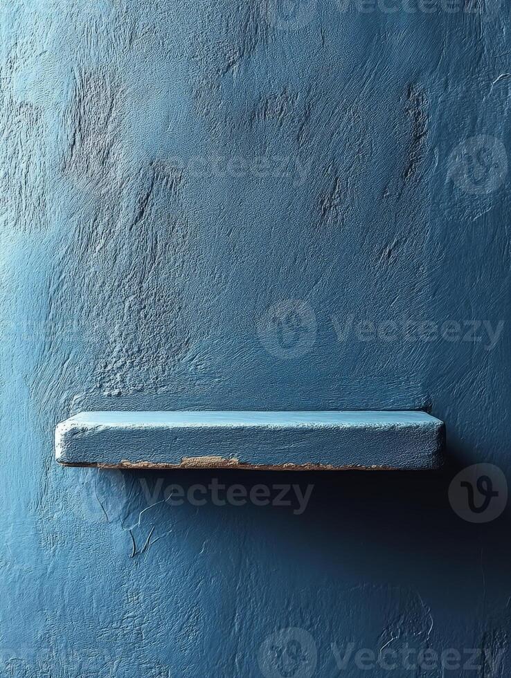 A simple blue wall with a small shelf, emphasizing minimalism and color. photo