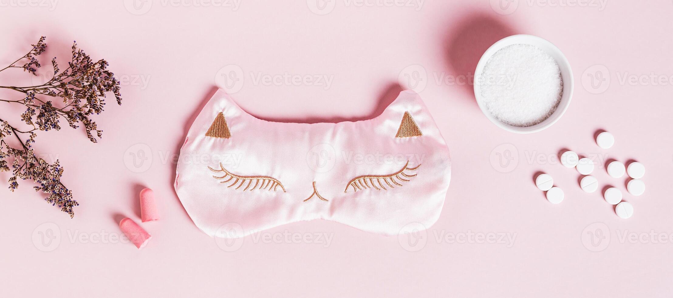 Concept insomnia sleep mask, earplugs, sleeping pills and magnesium powder on pink background photo