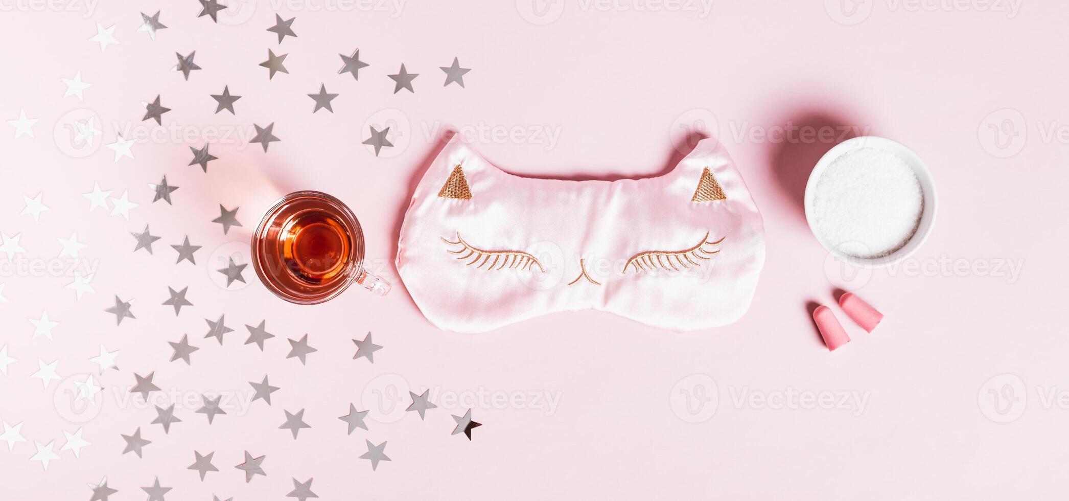 Concept good sleep, magnesium powder, sleep mask, cherry juice and earplugs on pink background photo