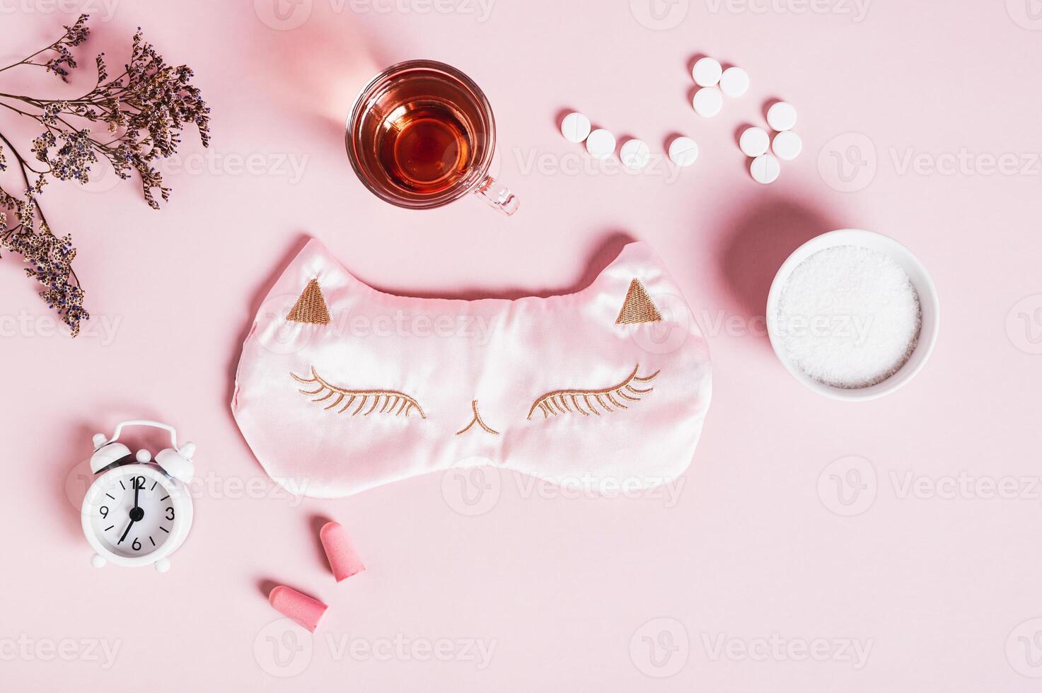 Concept insomnia accessories and sleep medications on pink background top view photo
