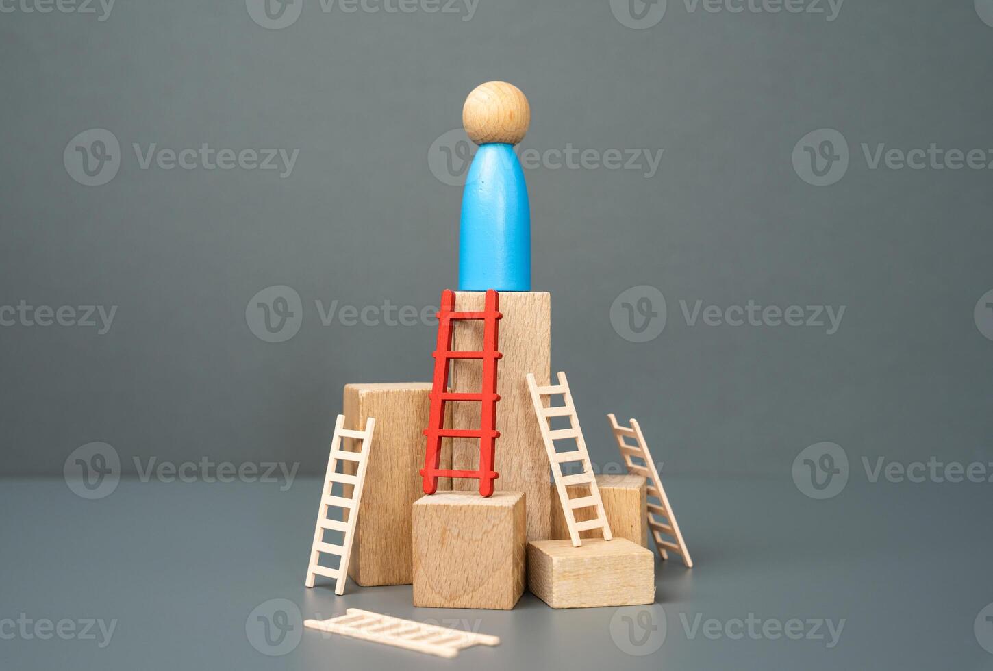 Man figure climbed to the top using the red ladder as a symbol of the correctly chosen method or tool. Achieve success, choose the right path, take out a loan to start a business or fulfill a dream. photo