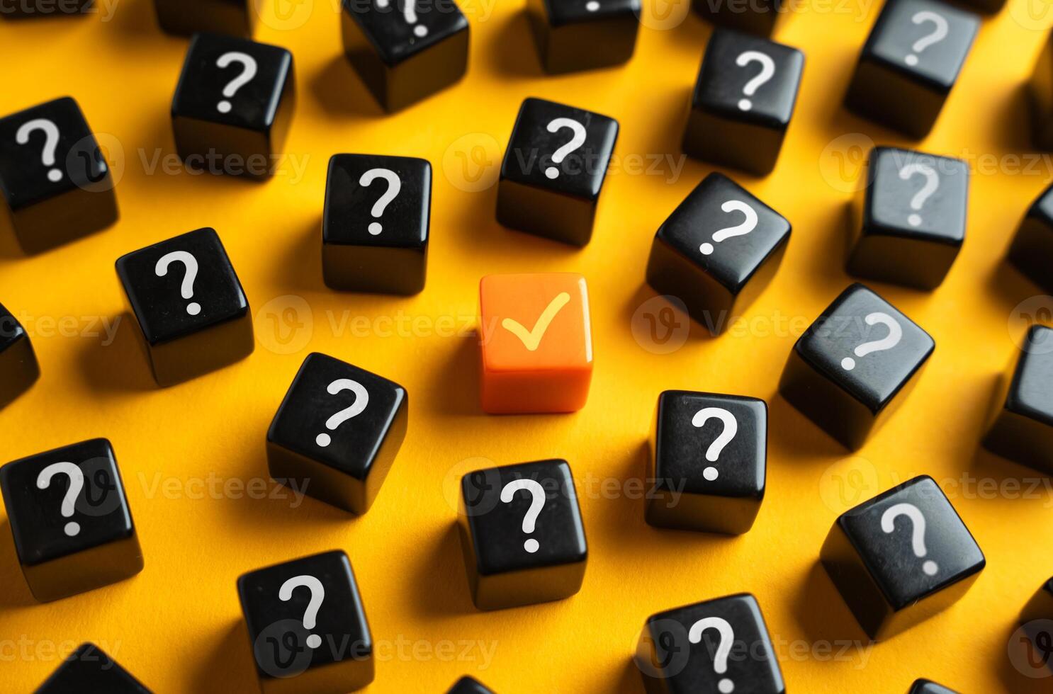 An orange check mark among many question marks. Correct answer. Task completion. Open achievement. Many unknown things and challenges. Fulfillment of requirements. photo