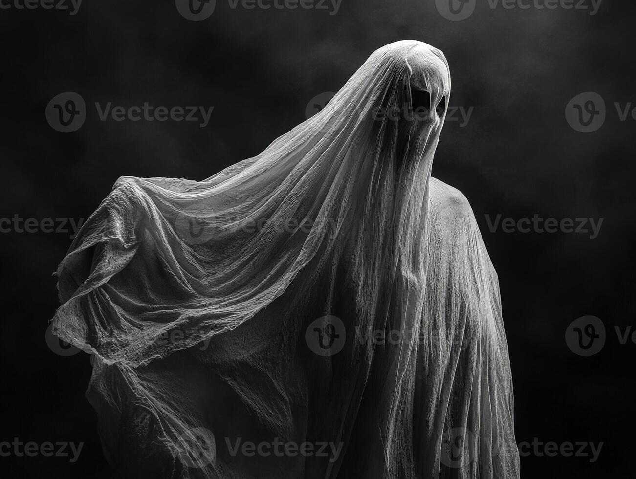 Mysterious figure shrouded in wispy fabric in a dark atmosphere photo