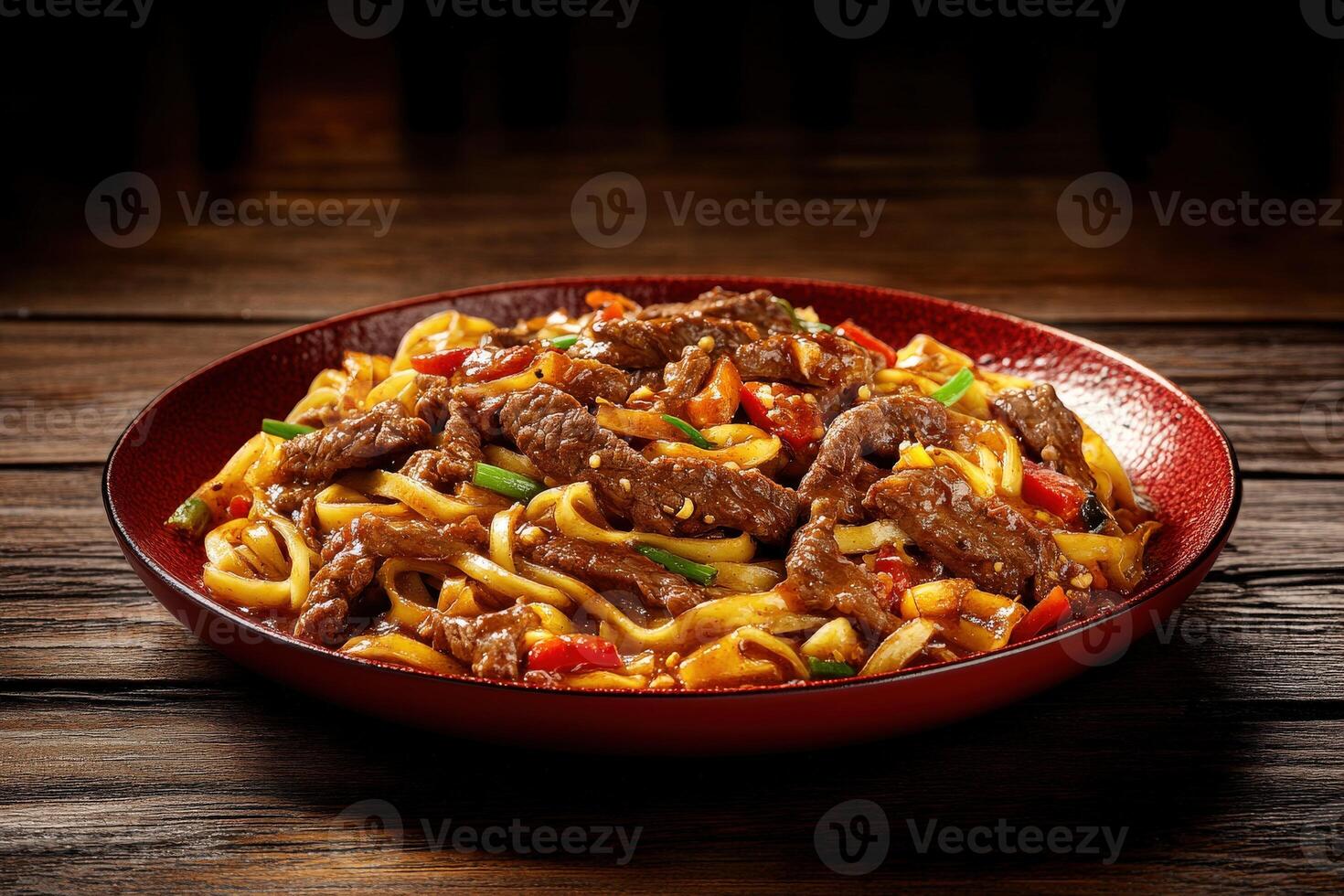Savory beef stir-fry with noodles and colorful vegetables on a wooden table photo