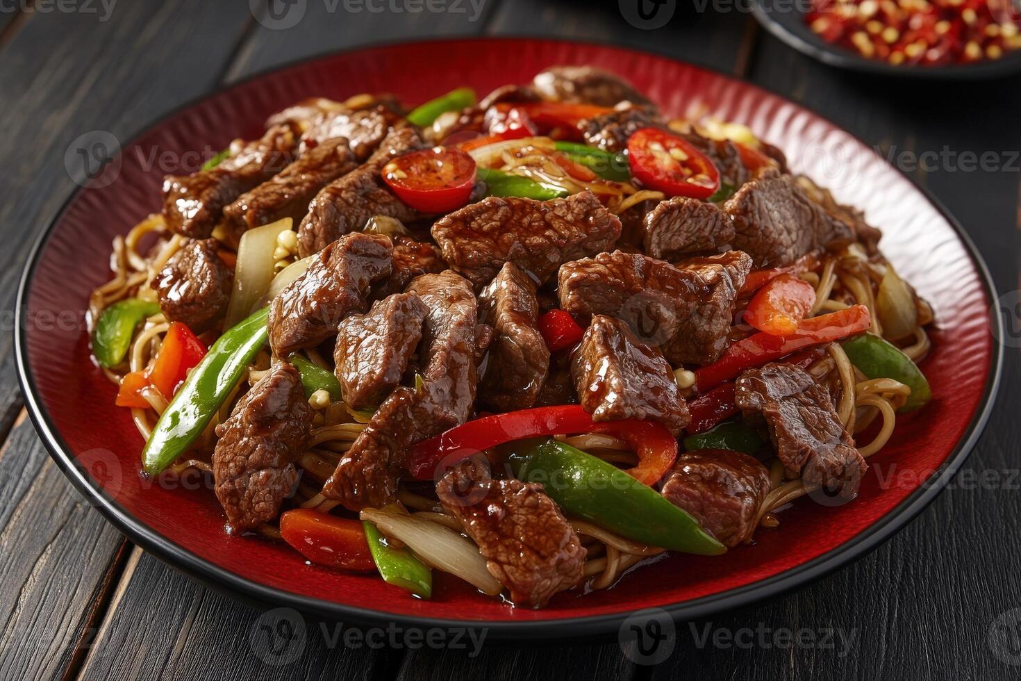 Delicious stir-fried noodles with beef and vibrant vegetables served in a bowl photo