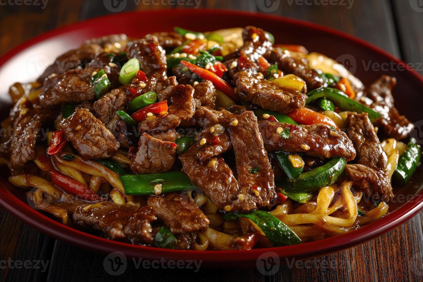 Delicious stir-fried beef with vegetables and noodles served in a bowl photo
