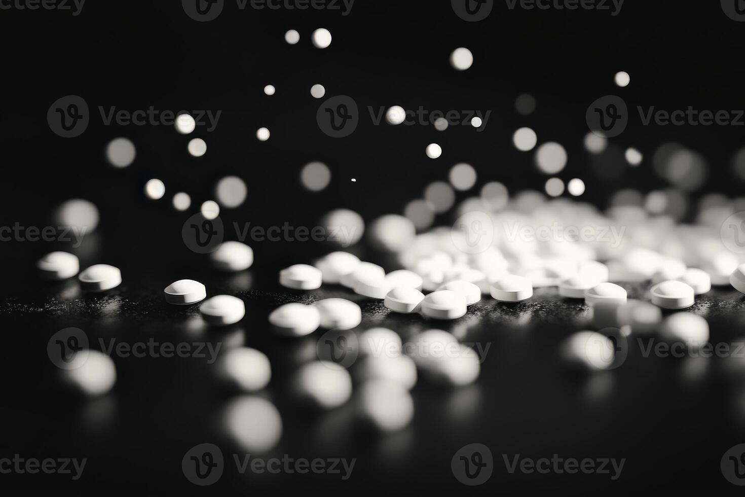 Sprinkling white granules on a dark surface creates a stunning visual effect photo