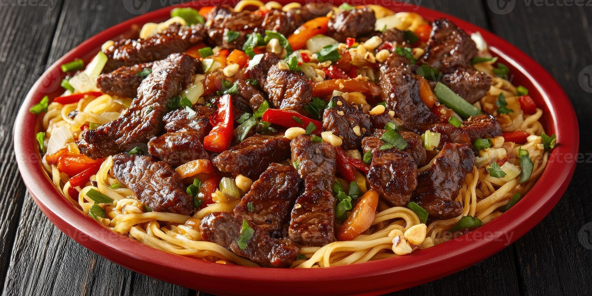 Delicious beef stir fry with noodles and colorful vegetables in a red bowl photo