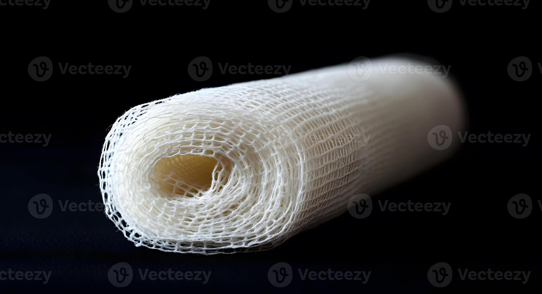 Rolled White Mesh Fabric On Dark Background photo