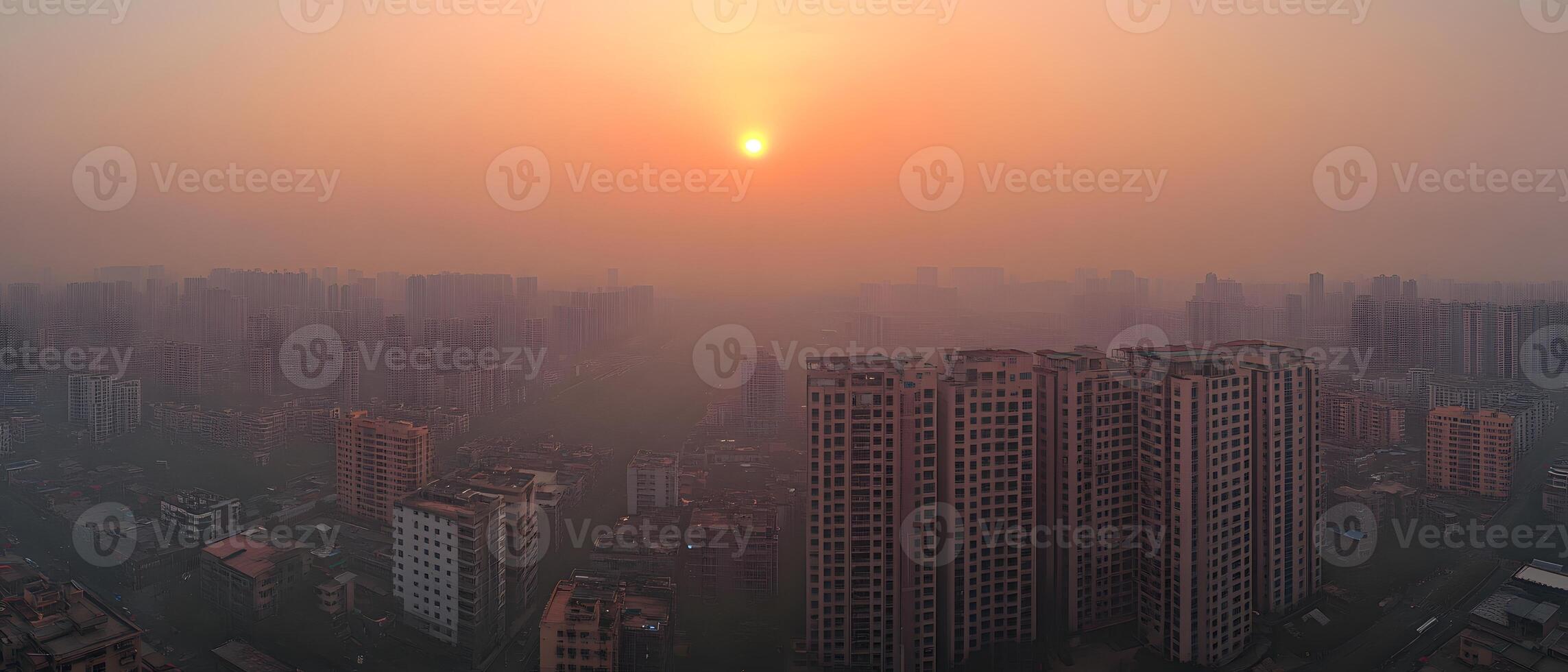 Sunset over a hazy cityscape of tall buildings photo